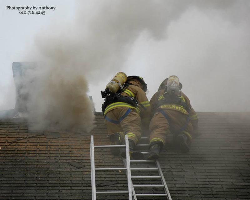 Ladder 77's Crew cutting holes on the roof