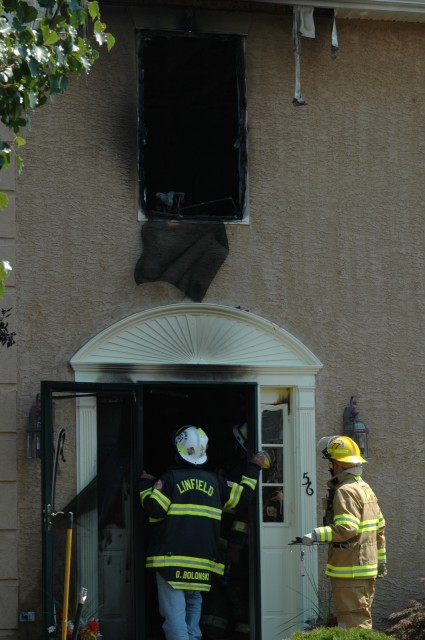 Trappe FF Wes Smith maintains accounability at the front door under the watchful eye of Linfield Fire Chief Don Bolonski.    Fire at 56 Edmonds Drive Limerick Twp.
Photos Courtesy of Tom Kelly, III
